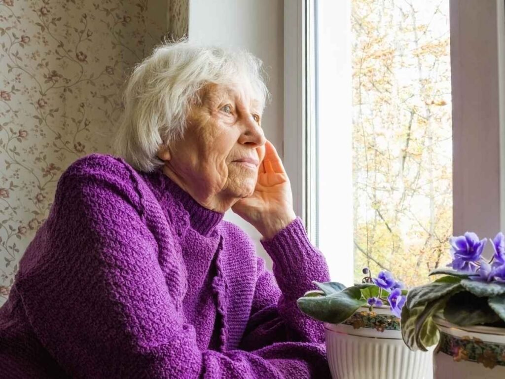 thoughtful person sitting by window natural light