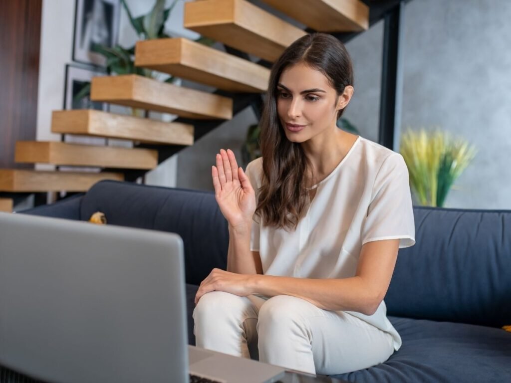 Person having an online therapy session on a laptop at home, representing accessible mental health support